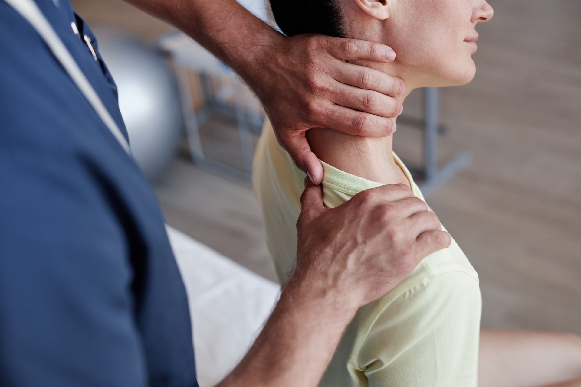 Close-up of a manual therapist massaging the neck of a young woman during therapy in a clinic. Close-up of a manual therapist massaging the neck of a young woman during therapy in a clinic.